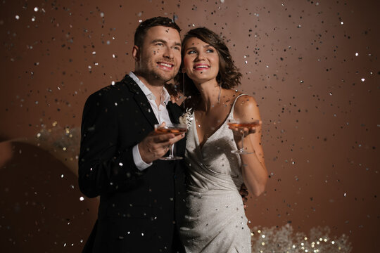Happy Newlyweds With Confetti Rain 