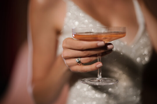Close Up Female Hand Holding Cocktail Glass