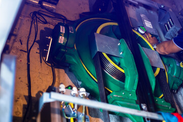 Selective focus to part of elevator lift equipment with hand of lift machinist repairing elevator. © Koonsiri