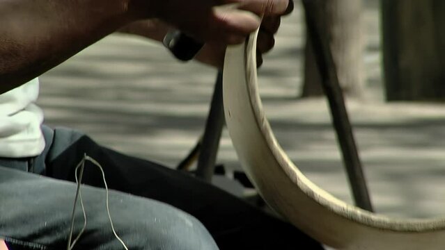 Man Making a "Bombo Leguero", an Argentine Drum made with Wood and Animal Leather, used in Local Traditional Folklore Music. Close Up.