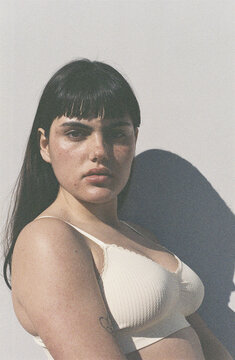 Confident brunette in white bra film portrait