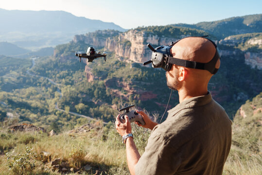 Male UAV pilot using controller and launching drone