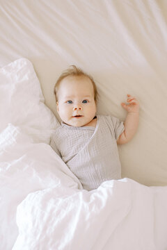Portrait Of Cute Baby On Bed