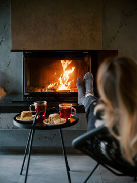 Tea Cups And Cake In Front Of House Fireplace