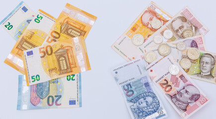 Euro and kunas and coins on a white background. Money of tourist countries.