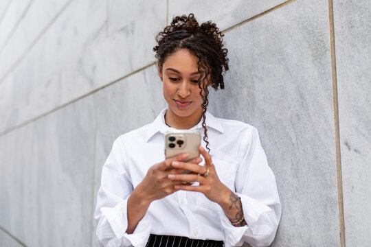 An Intern Uses Her Phone While On Break From Work