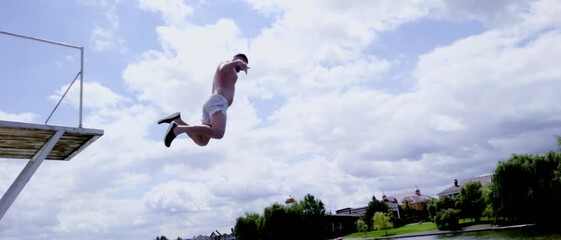 Man leaping off an elevated platform or diving board