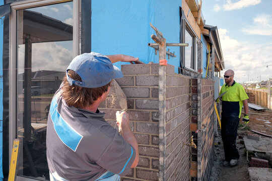 Bricklayer building external house wall