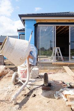 House build with cement mixer in foreground