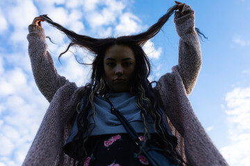 girl with horns on the background of the sky