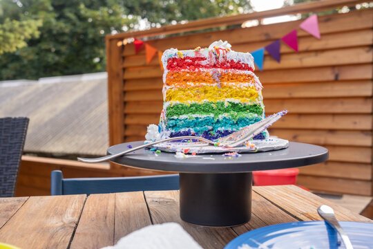 Half-eaten rainbow birthday cake