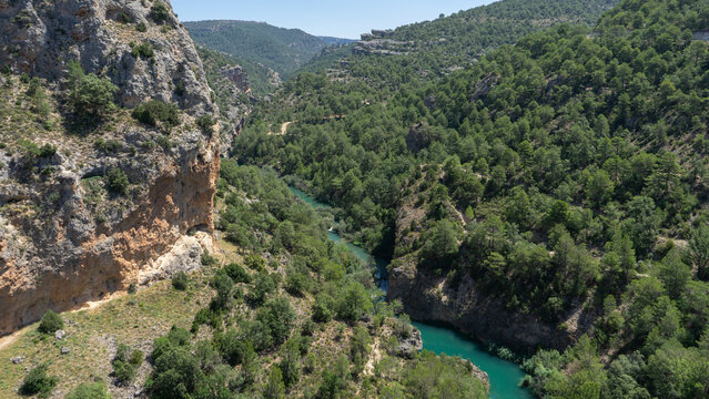 Viewpoint and photo taken from the Ventano del Diablo, Cuenca. There we can see various mountains with lots of vegetation and green trees in the middle of summer 
