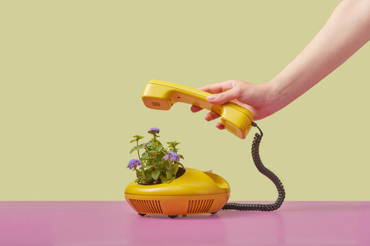 Hand holding vintage telephone handset