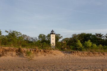 A lighthouse on the lake shore in the evening