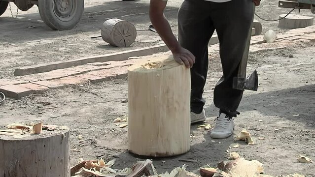 Drum Maker Cutting a Trunk While Making a "Bombo Leguero", an Argentine Drum made with Wood and Animal Leather, used in Local Traditional Folklore Music. Low Angle View. 