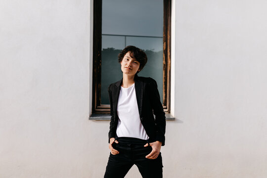 Content non binary person near building