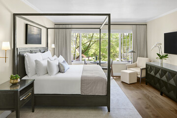 Luxury hotel bedroom with view of nature