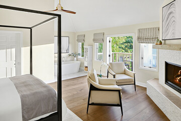 Luxury hotel room with balcony, bathtub, and fireplace