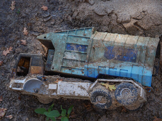 Abandoned broken toy trash truck found discarded