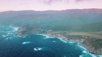 World famous scenic drive by Big Sur nature park, Bixby bridge. Drone footage over outstanding beauty of adventurous tourist destination with coastal landscape. High quality 4k footage