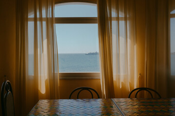 Window with a view of the Mediterranean Sea in dining room