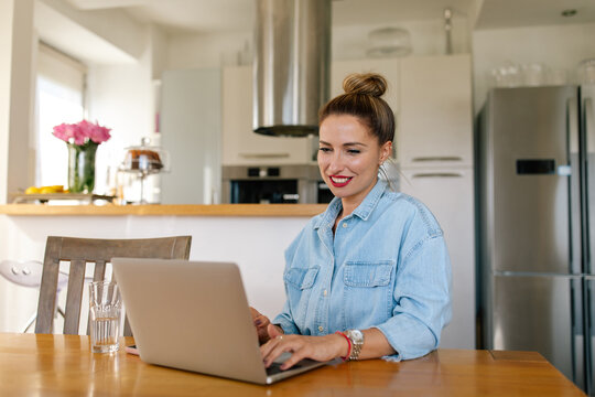 Woman Video Chatting Via Her Laptop