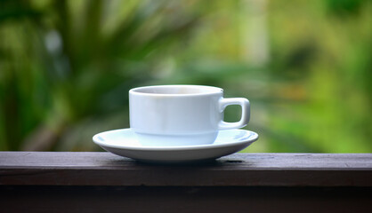 Coffee is a cup of coffee placed on the floor.