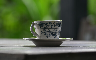 Coffee is a cup of coffee placed on the floor.