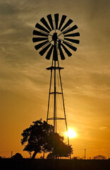 Weather pump wheather vane at sunset in the background in Paraiba, Brazil.