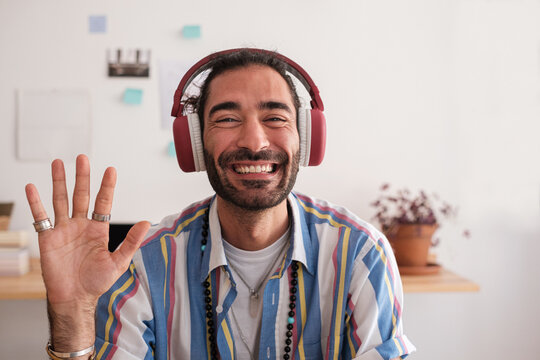 Friendly businessman waving hand in Video Call