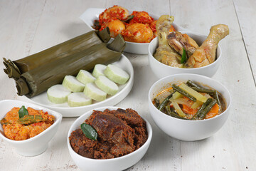 Lontong Lebaran, served with sambal goreng, opor ayam, sayur labu siam, rendang and telur balado. Traditional celebratory menu during Eid al-Fitr and Eid al-Adha in Indonesia