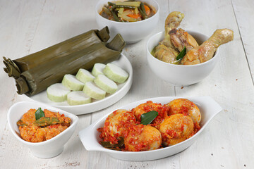 Lontong Lebaran, served with sambal goreng, opor ayam, sayur labu siam, rendang and telur balado. Traditional celebratory menu during Eid al-Fitr and Eid al-Adha in Indonesia