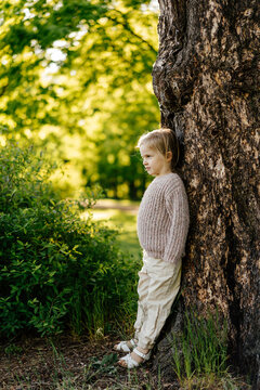 standing near tree trunk in countryside