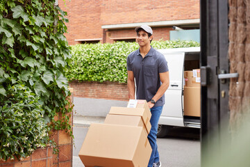 Delivery man pushing trolley with parcels