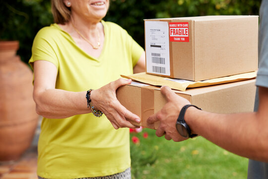 Friendly customer receiving parcels from courier