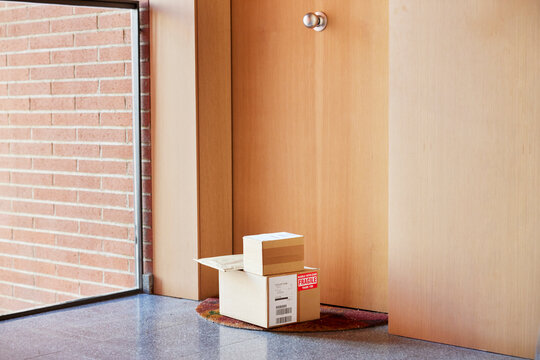 Parcels stacked outside modern flat
