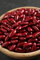 Raw red kidney beans in wooden bowl, closeup