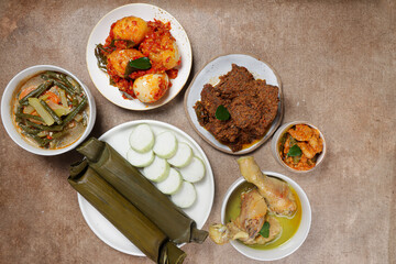 Lontong Lebaran, served with sambal goreng, opor ayam, sayur labu siam, rendang and telur balado. Traditional celebratory menu during Eid al-Fitr and Eid al-Adha in Indonesia