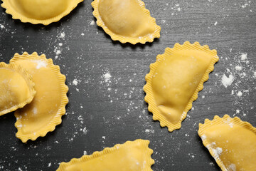 Ravioli on grey wooden table, flat lay. Italian pasta
