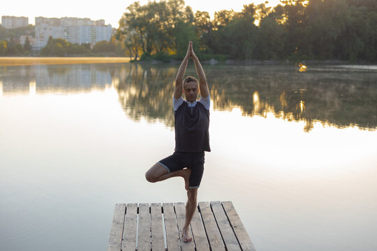 man doing yoga in vrikshasana asana
