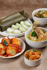 Lontong Lebaran, served with sambal goreng, opor ayam, sayur labu siam, rendang and telur balado. Traditional celebratory menu during Eid al-Fitr and Eid al-Adha in Indonesia