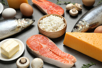 Fresh products rich in vitamin D on grey table