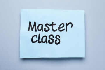 Paper note with words Master Class on grey background, top view