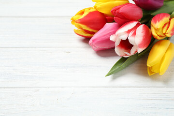 Beautiful spring tulips on white wooden table, closeup. Space for text