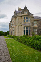Fototapeta na wymiar Killarney National Park, Co. Kerry, Ireland: A walkway along the side of Muckross House, a 65-room Victorian mansion built in 1843.