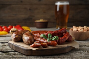 Set of different tasty snacks on wooden table, closeup view