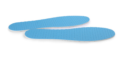 Pair of light blue insoles on white background