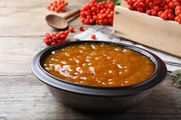 Delicious rowan jam in bowl on wooden table