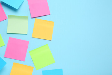 Blank colorful sticky notes on turquoise background, flat lay. Space for text