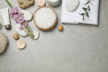 Flat lay composition with cosmetics on grey marble table, space for text. Spa treatment